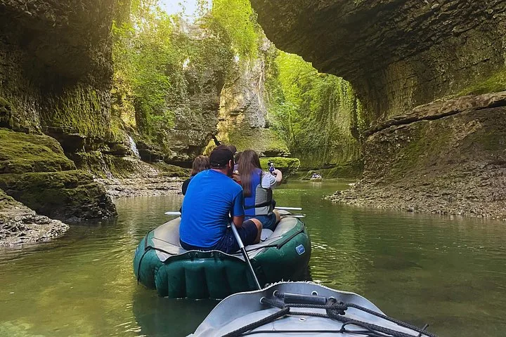 Tourists on inflatable rafts exploring the scenic river of Martvili Canyon