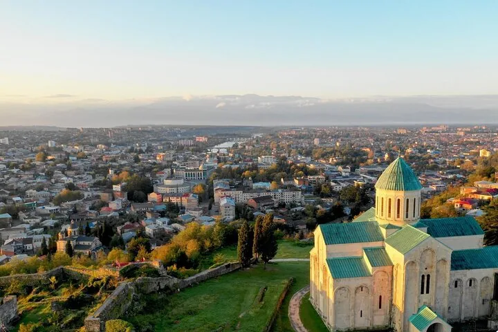 Stadtansicht von Kutaissi mit der Bagrati-Kathedrale im Vordergrund bei Sonnenuntergang